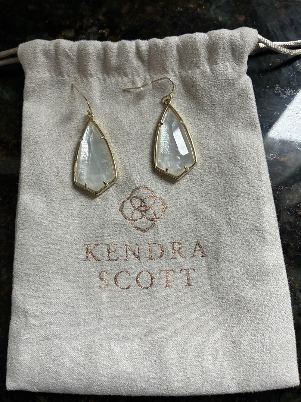 Kendra Scott gold Carla earrings in mother of pearl.